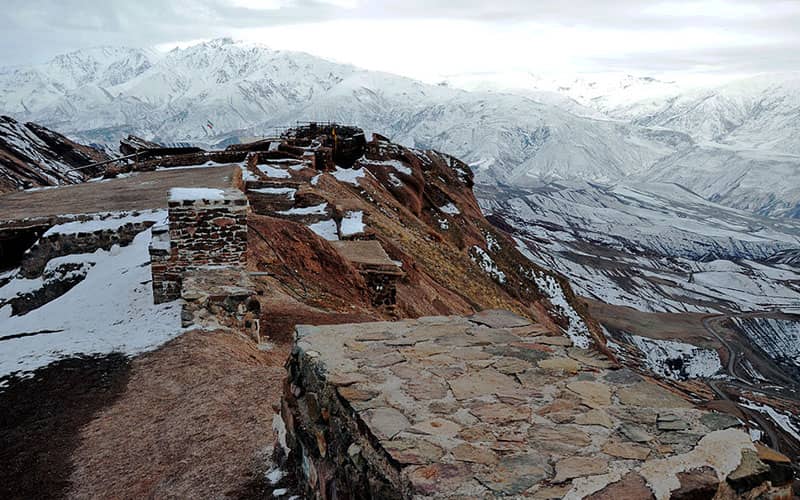Ruins of Alamut Castle walls and towers against the Alborz sky