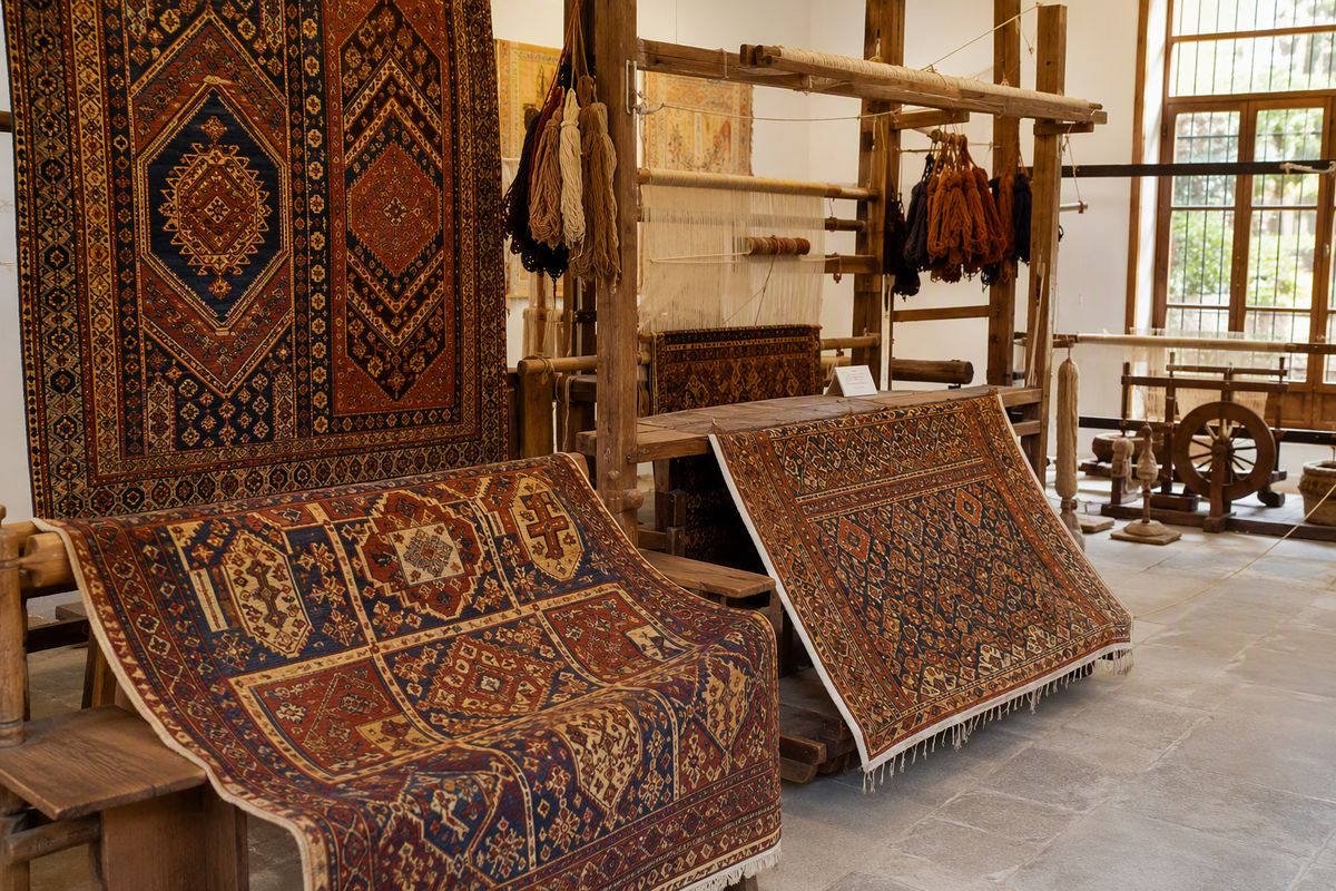 Historical carpets and weaving tools on display