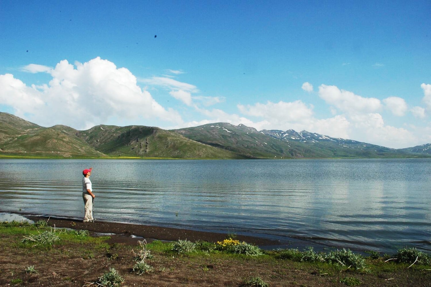 Neor Lake surrounded by alpine meadows and forest