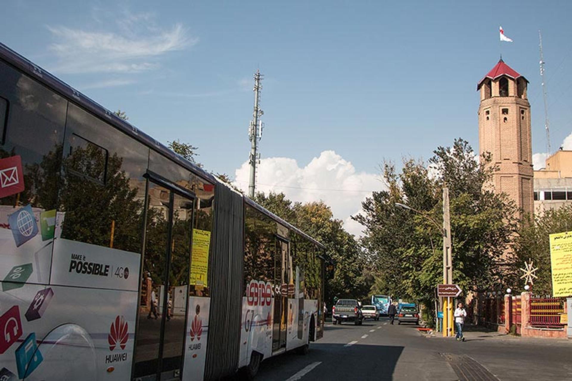 A city BRT bus passing on the street in front of the Atshanshani Tower