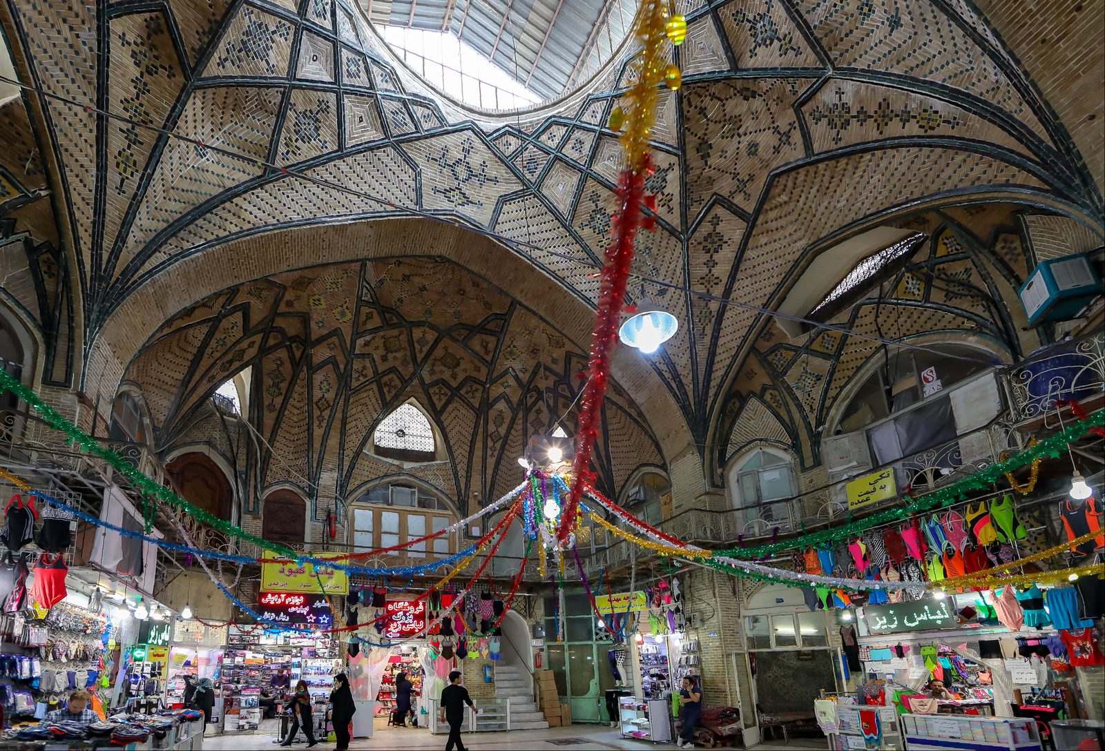 Colorful spice stalls in a traditional Iranian bazaar with sacks of turmeric and saffron