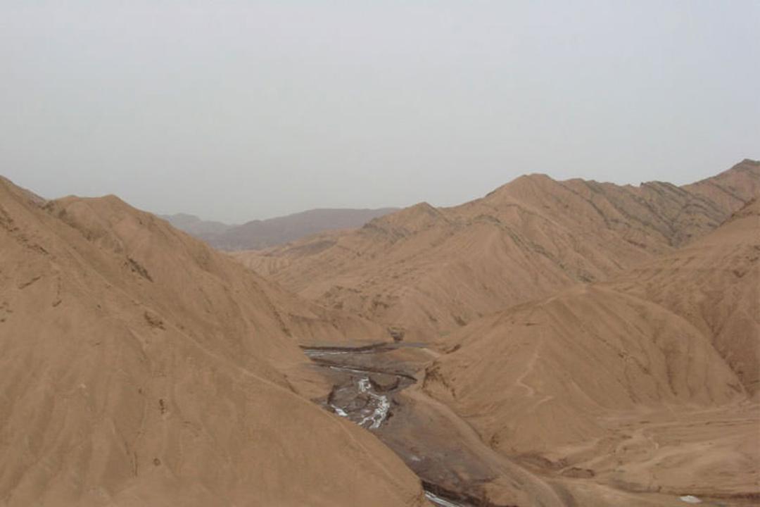 Nomadic tents on the edge of Garmsar Plain with Alborz foothills in the background