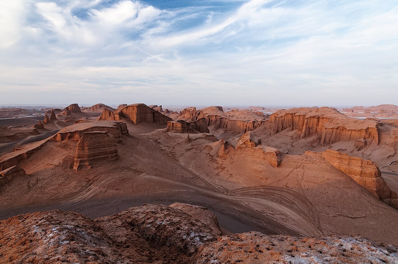 Layered yardangs carved by wind in the heart of the Lut Desert