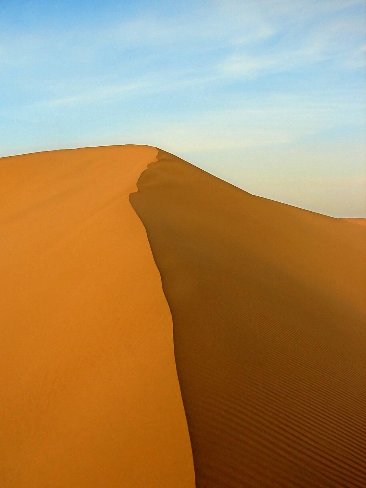 Pristine sand dunes rising above the Maranjab Desert floor