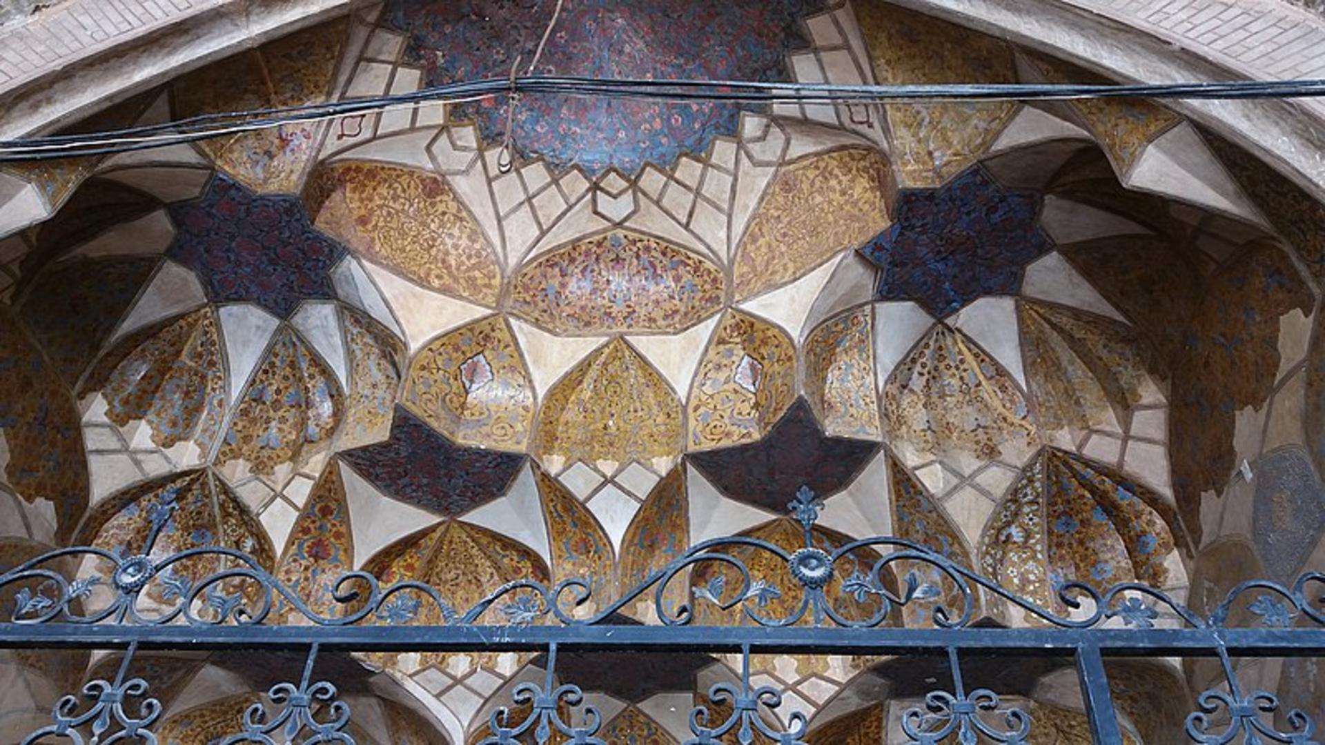 The painted muqarnas half-dome of the entrance portal at the Ali Mardan Khan ab anbar in Yazd