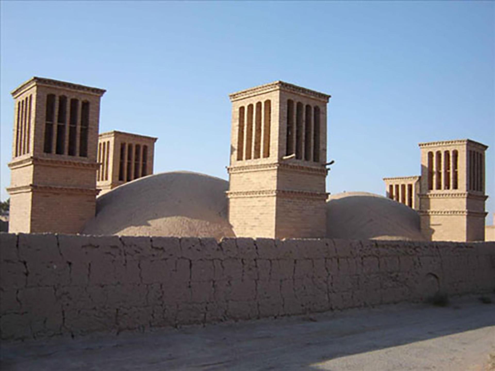 The row of brick windcatchers above the domes of the Seven-Windcatcher ab anbar at Asrabad in Yazd province