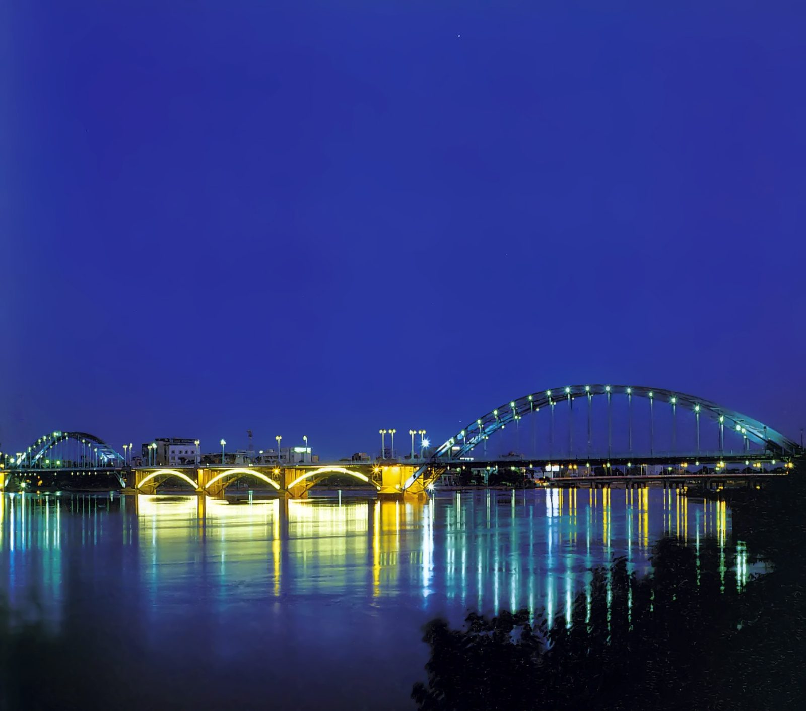 Night view of Ahvaz bridges reflecting light on the Karun River