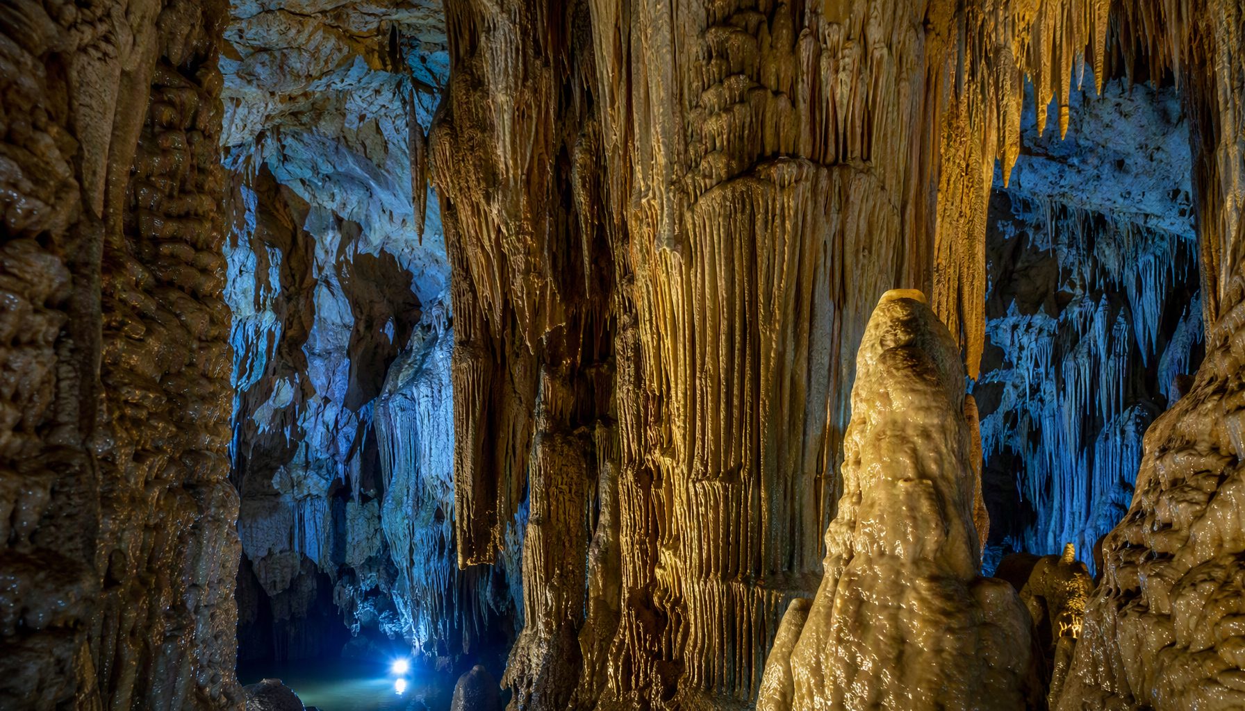 Stalactites and stalagmites forming natural pillars inside Ali Sadr Cave