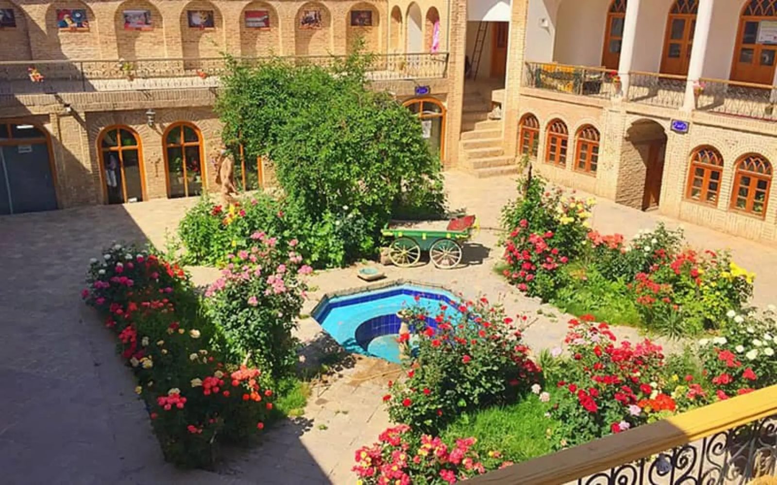 Courtyard and pool of the Hajajermiha Hussainiya, its brick arches and iwan facing inward