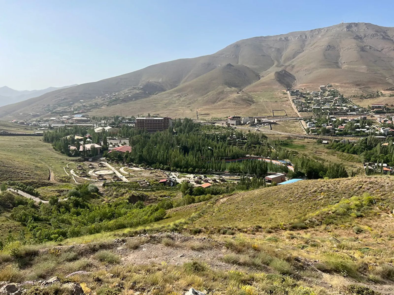 Masha plain and its village, green with trees under the ridges