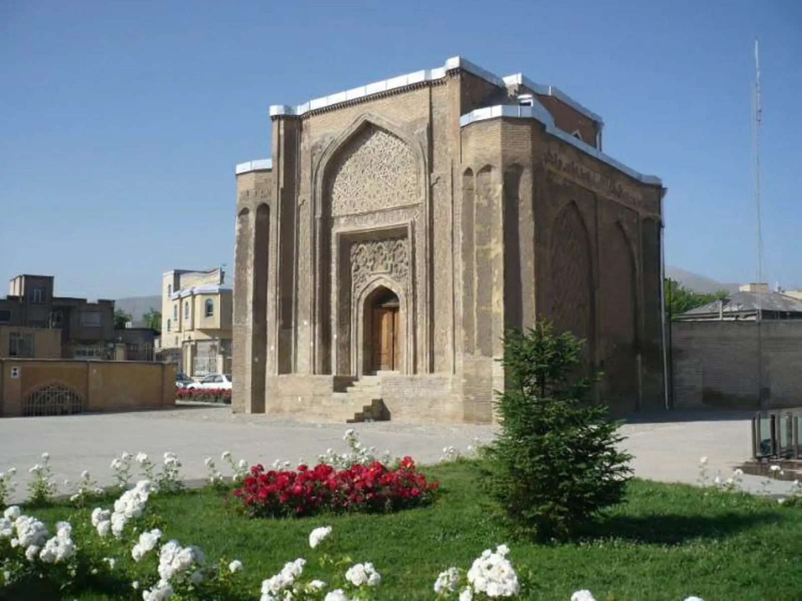 The Alavian Dome standing beside a green square in Hamadan