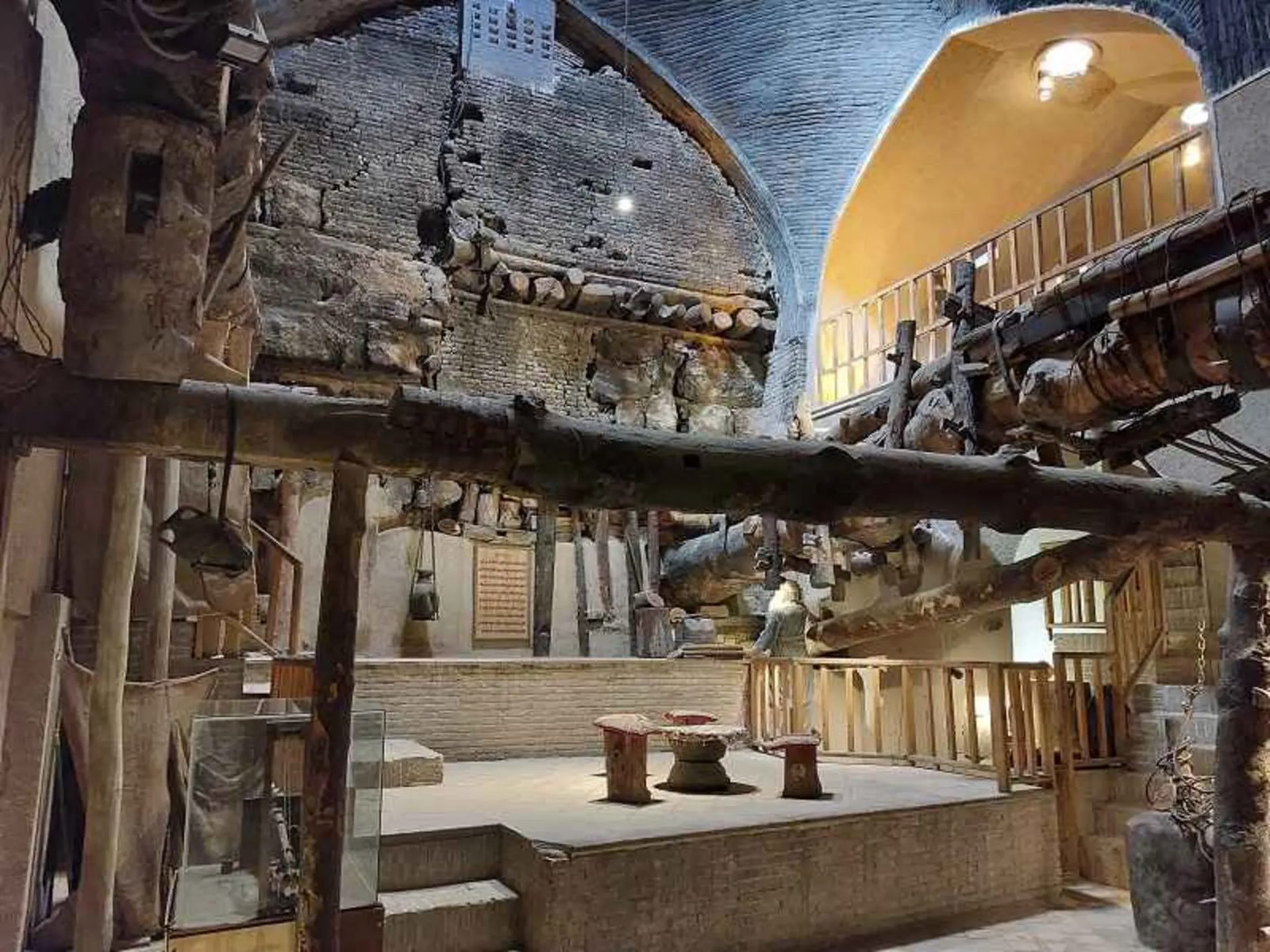 The vaulted oil-press hall of the Asarakhaneh Museum with its wooden presses and tools