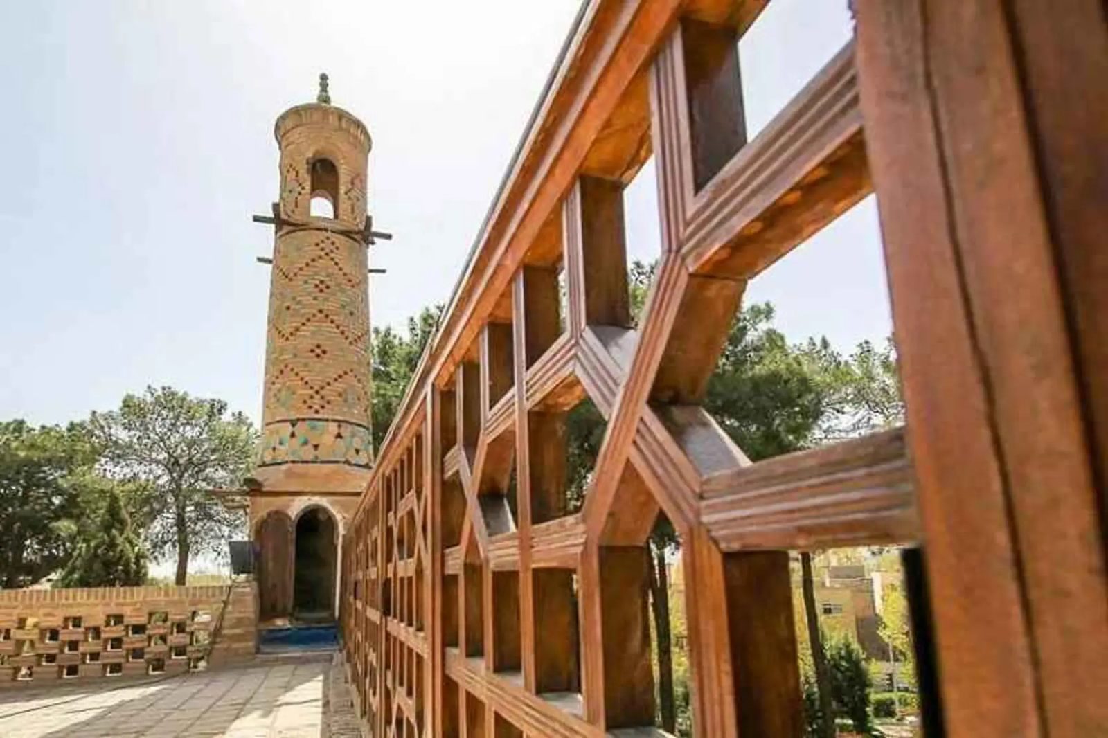 The brick minaret and wooden lattice walkway of Minar Janban