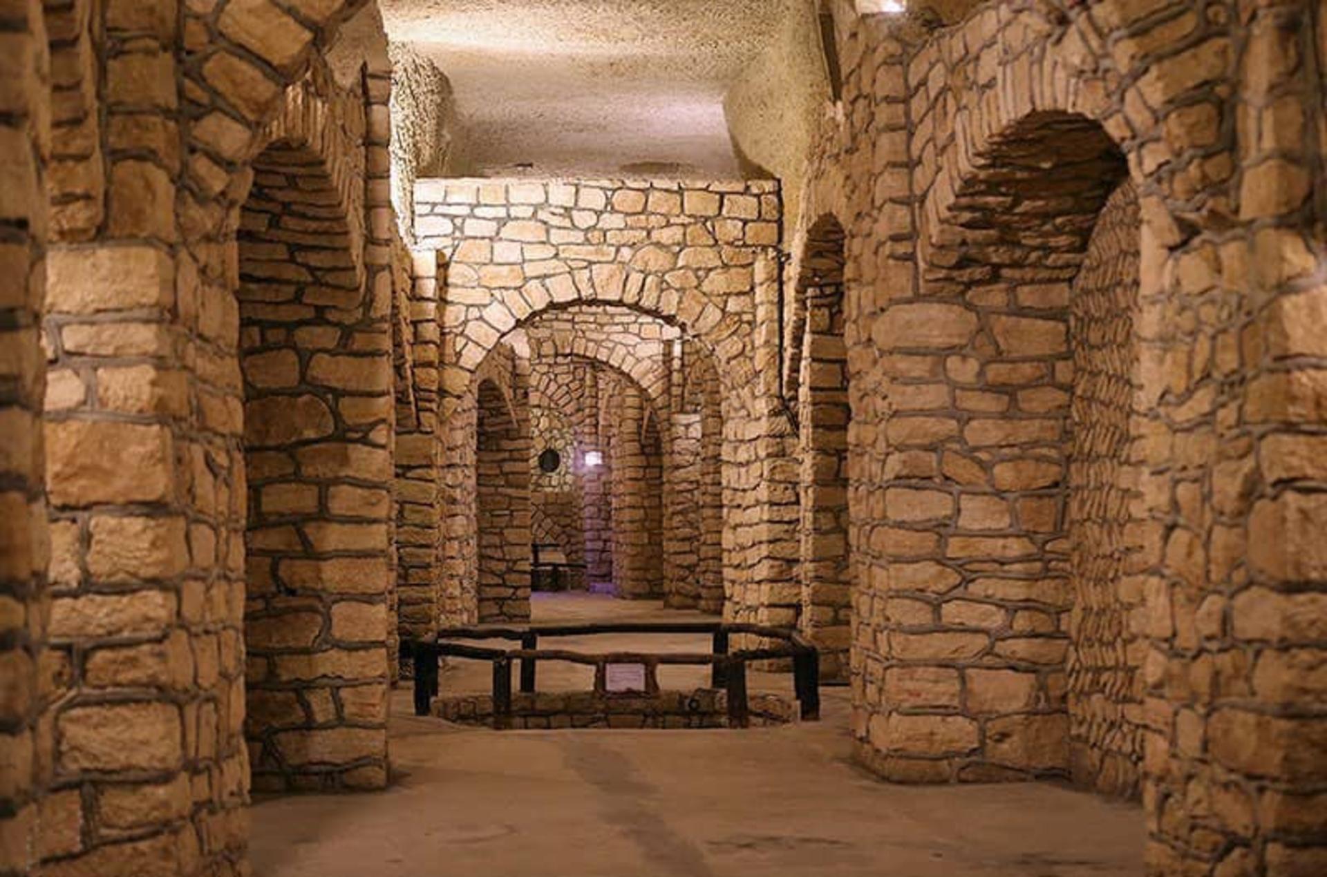 Stone corridors and arched ceilings inside the Kariz Underground City on Kish
