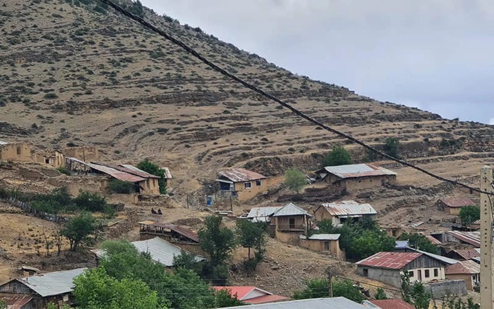 Angas village, its stone houses scattered up a dry terraced hillside