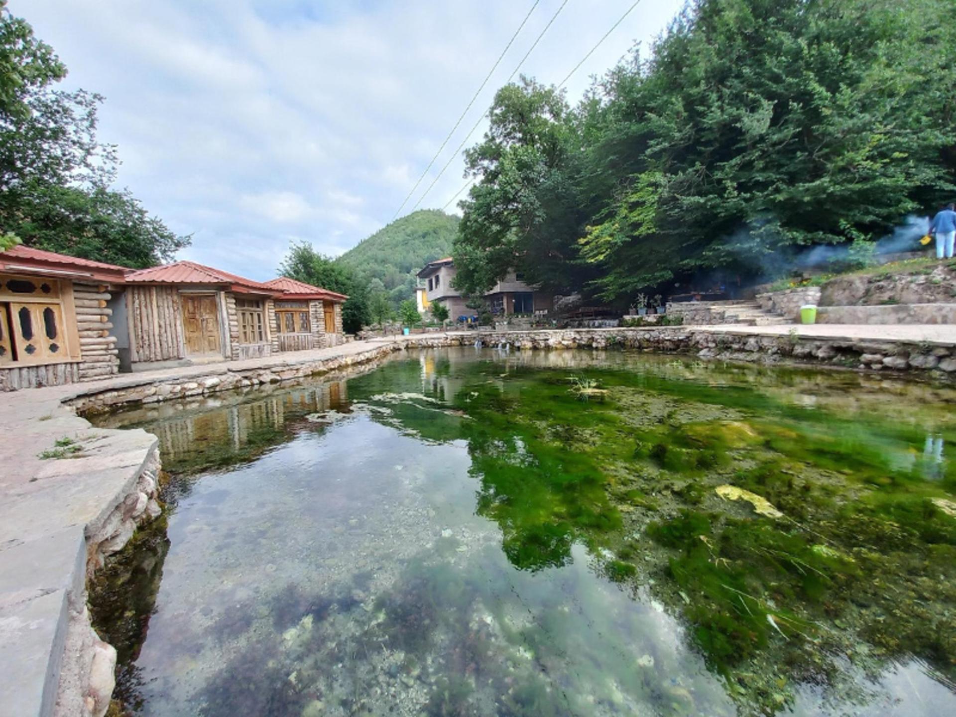 Simple lodges built beside the Div Cheshmeh spring