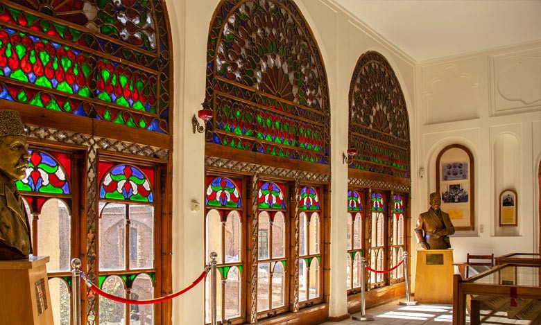 Interior of a domed carpet hall in the Tabriz Bazaar with light filtering through the ceiling