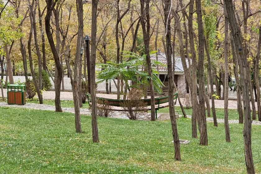 Wooden benches set among the flower beds at Bagh-e Rah Fadak